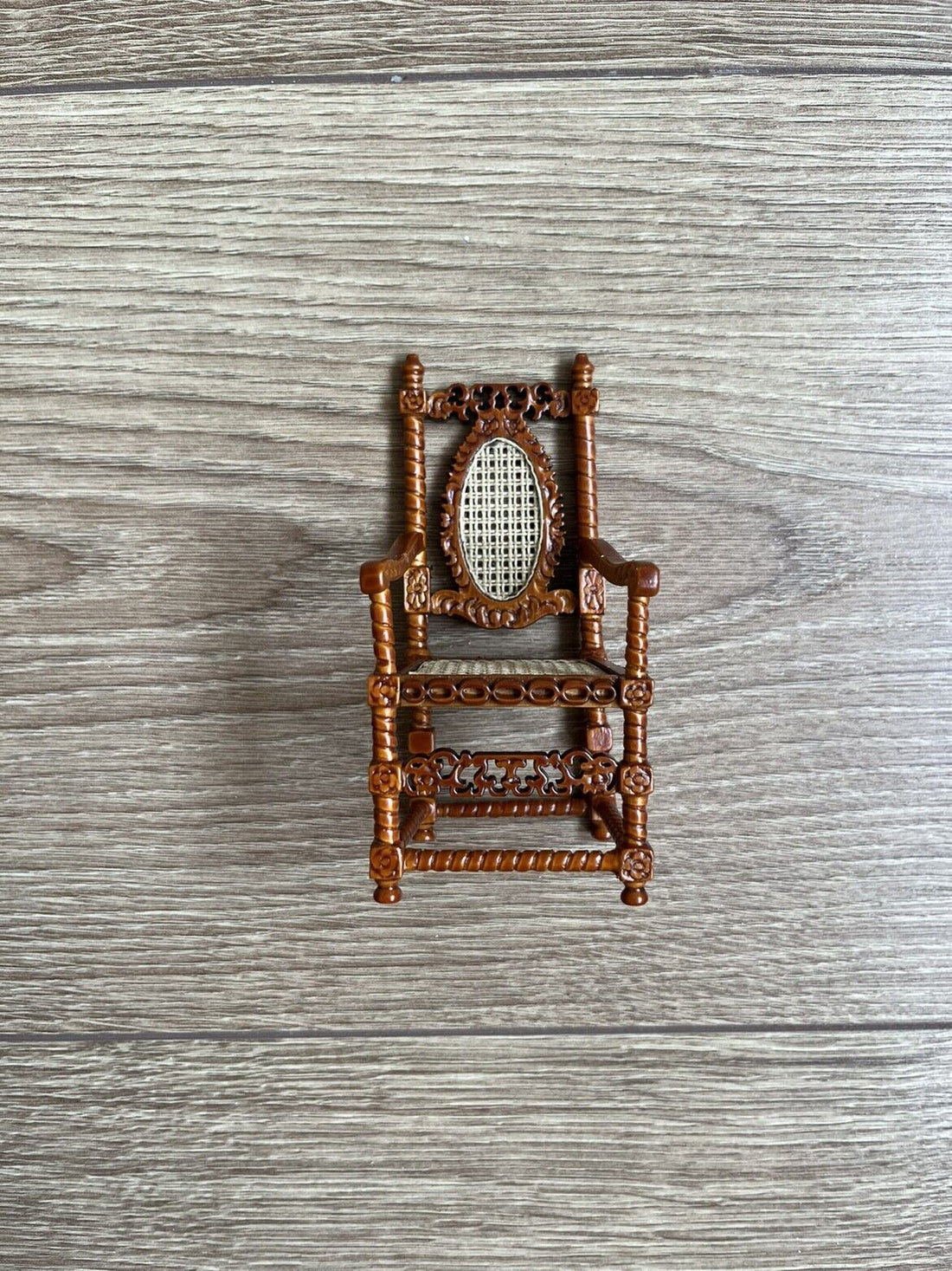 1:12 scale hand-carved walnut armchair with a woven mesh back